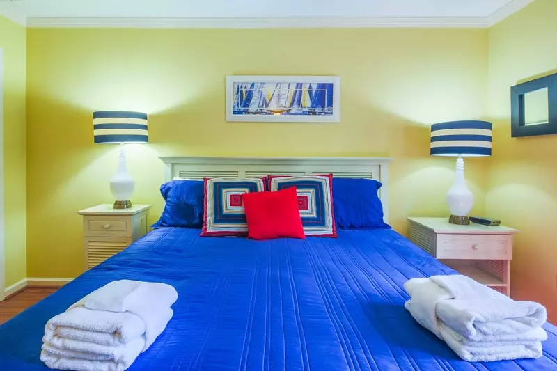 The master suite features a king bed with night stands and reading lamps.