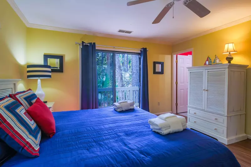 The master suite also features an armoire with flat screen TV, ceiling fan and an en suite bathroom.