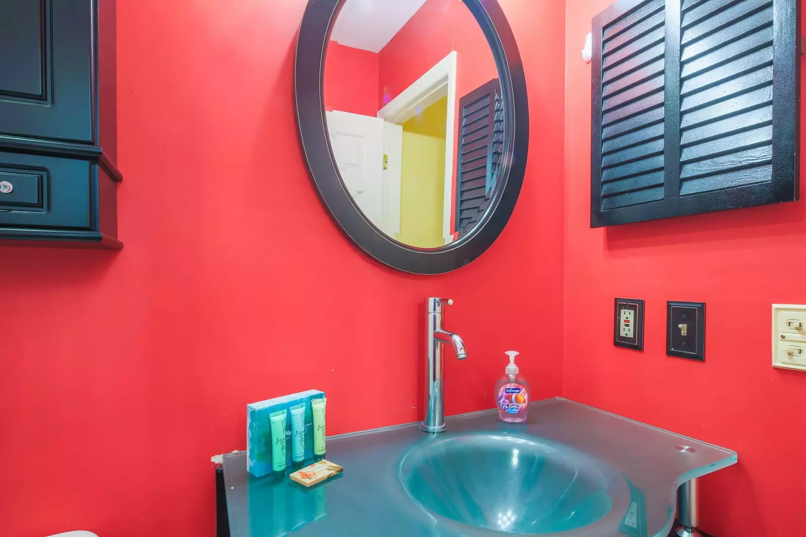 The en suite bathroom features a vanity and medicine cabinets for storage.