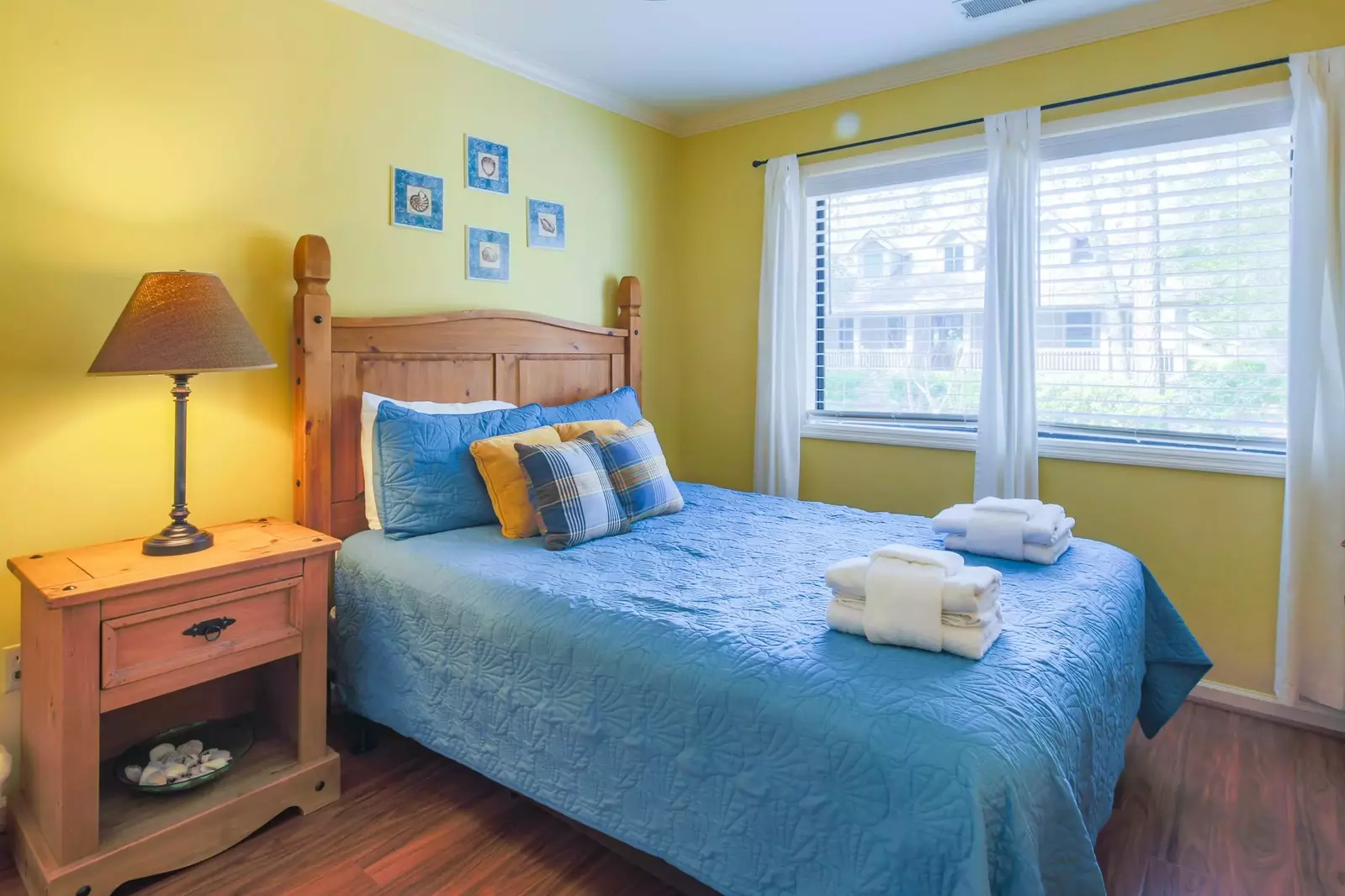 This guest bedroom features a full bed and night stand with reading lamp.