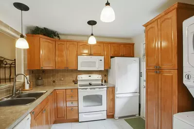 Renovated kitchen with solid surface counter tops, new cabinetry and appliances