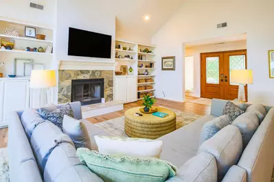 When you enter the home, you'll find this beautiful living room with vaulted ceilings and sectional sofa.