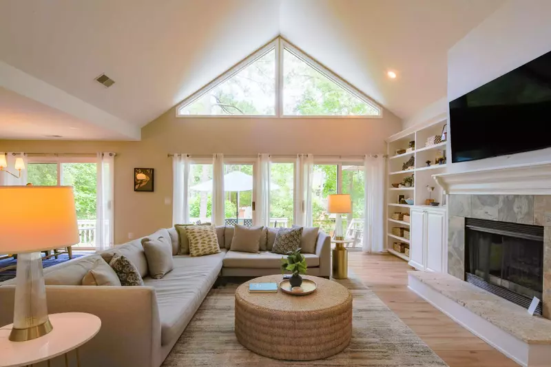 The sliding glass doors in the living room lead to the home's back deck and pool patio.