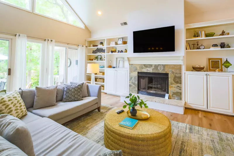 The living room is the perfect spot to gather together to watch a movie on the wall-mounted TV.