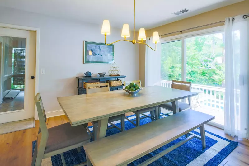 From the dining area you may access the back deck through the sliding glass door or the screened porch through the door.