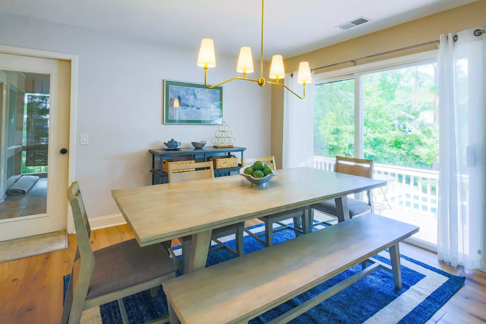 From the dining area you may access the back deck through the sliding glass door or the screened porch through the door.
