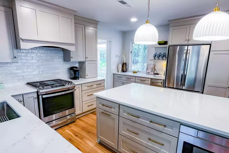 This renovated kitchen features stainless steel appliances, tiled backsplash and new cabinetry.