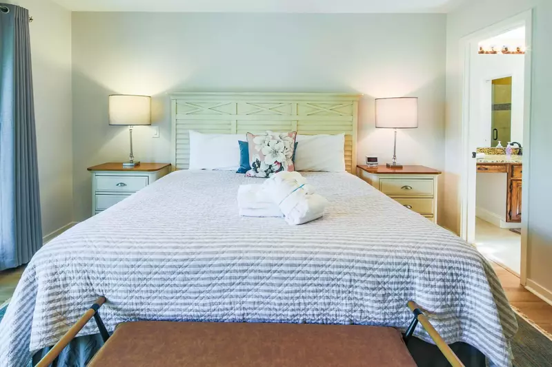 The en suite bathroom is just inside the doorway to the right of the bed.