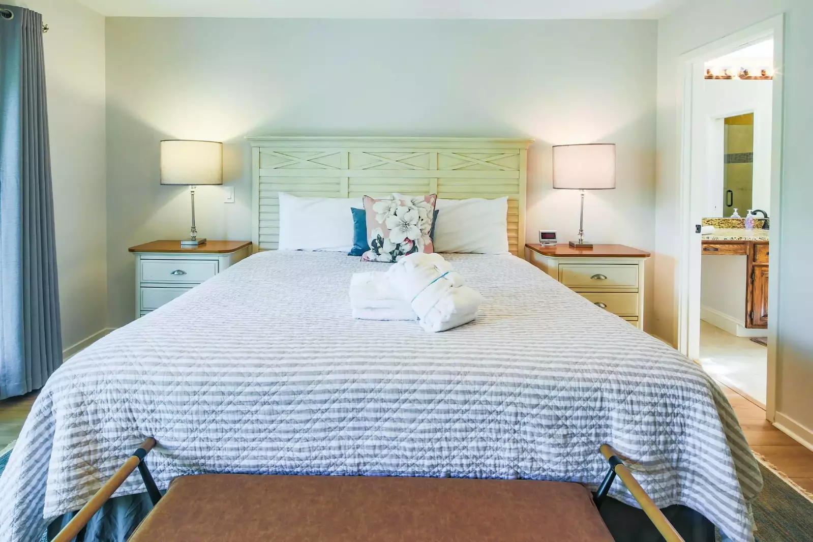 The en suite bathroom is just inside the doorway to the right of the bed.
