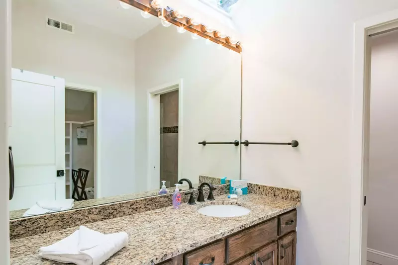 The en suite bathroom features a spacious vanity.