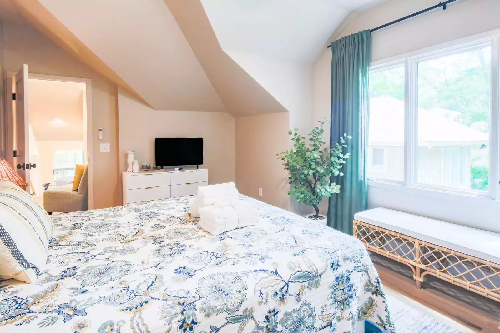 This guest bedroom also has a dresser and flat screen TV.