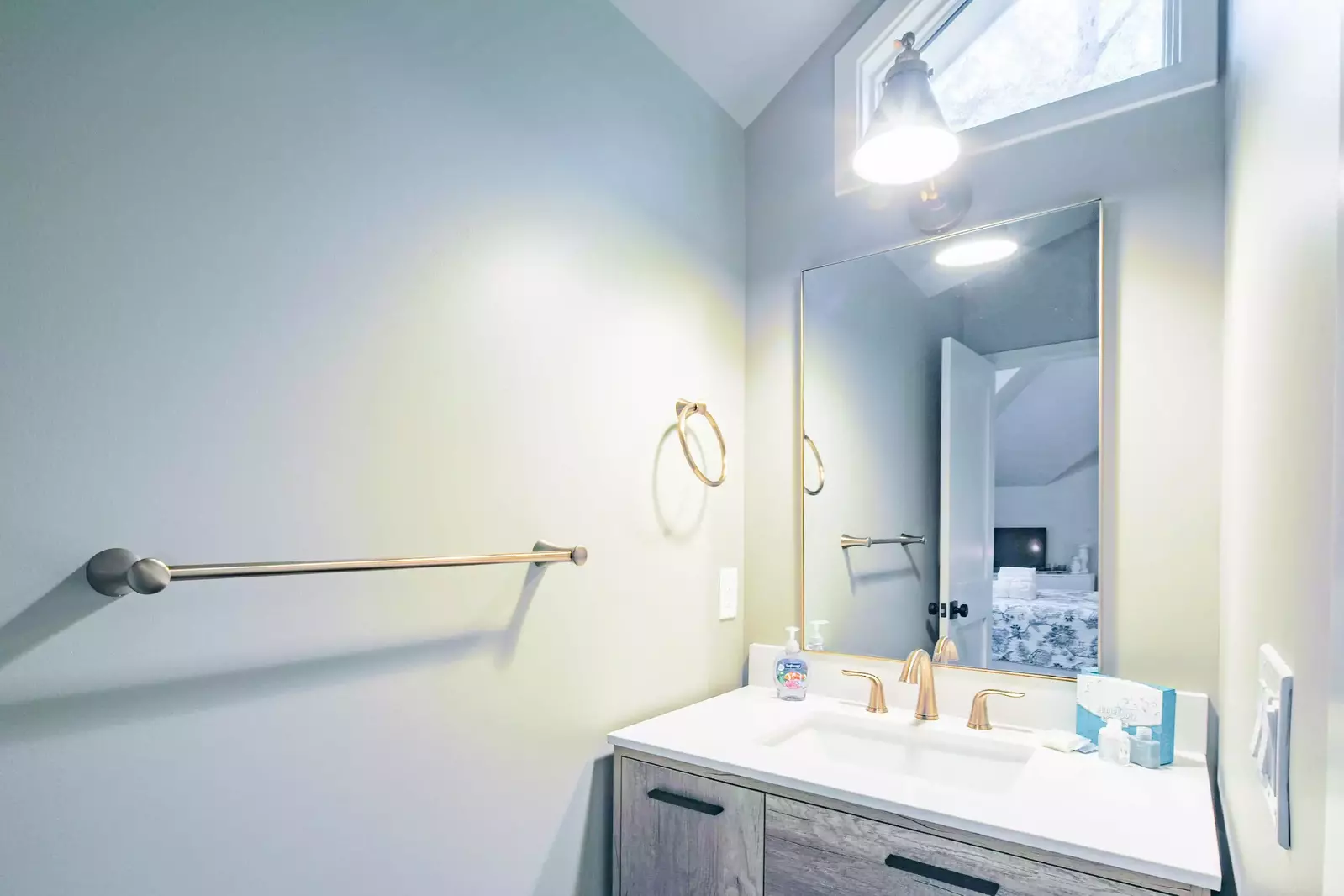 The jack & jill bathroom features a spacious vanity on each side of the shower.