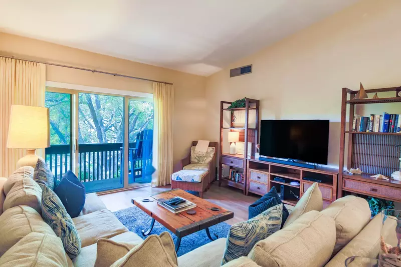 The comfortable living room has sliding door access to the balcony.