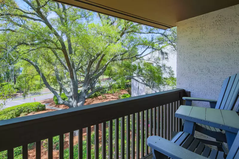 The covered balcony has high top seating and serene views.