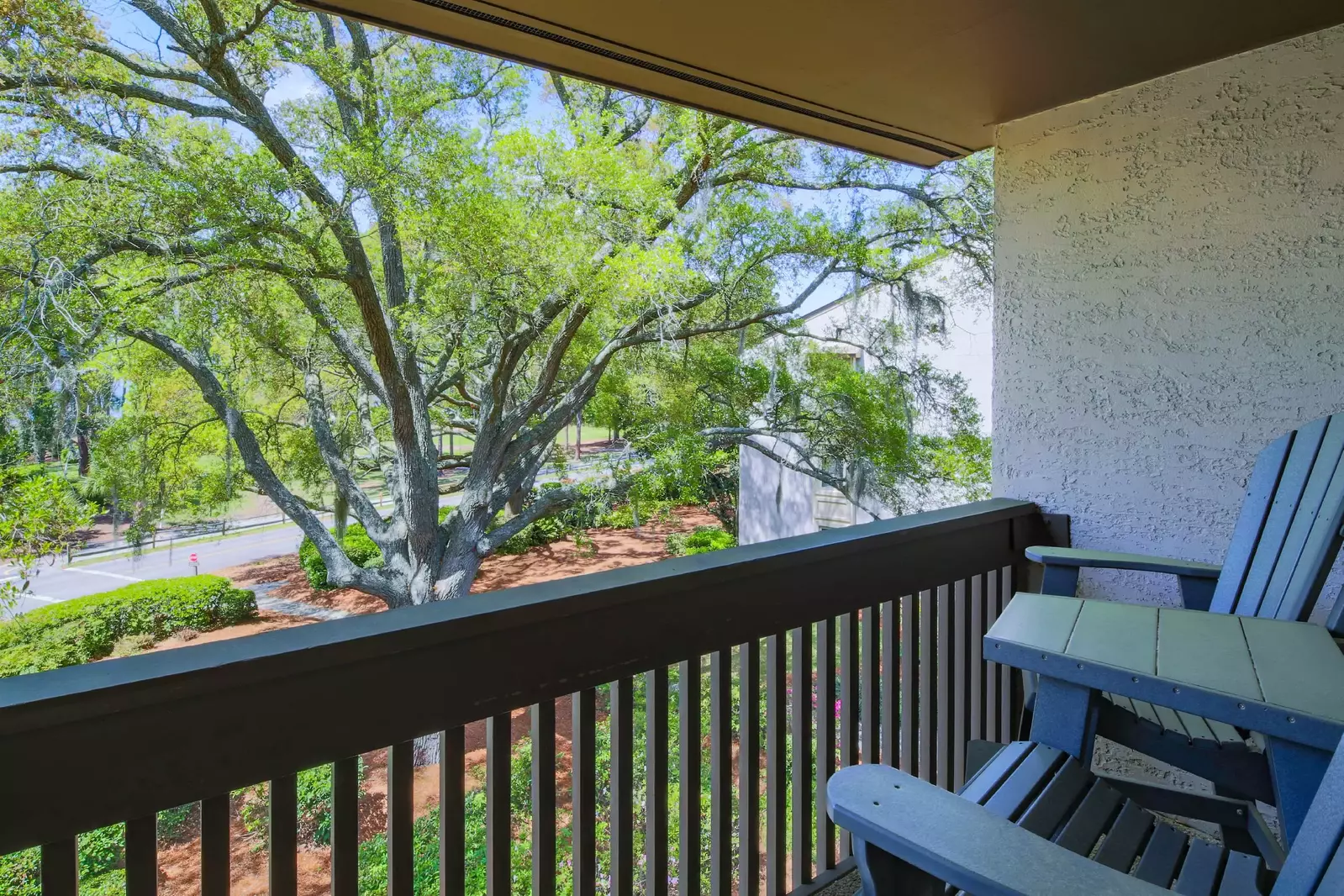 The covered balcony has high top seating and serene views.