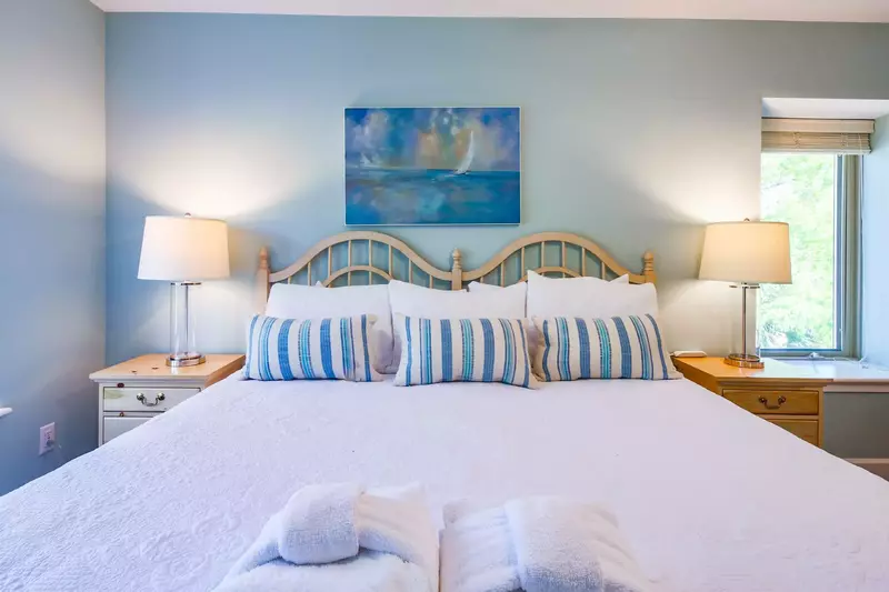 The master suite features a king bed and night stands with reading lamps.