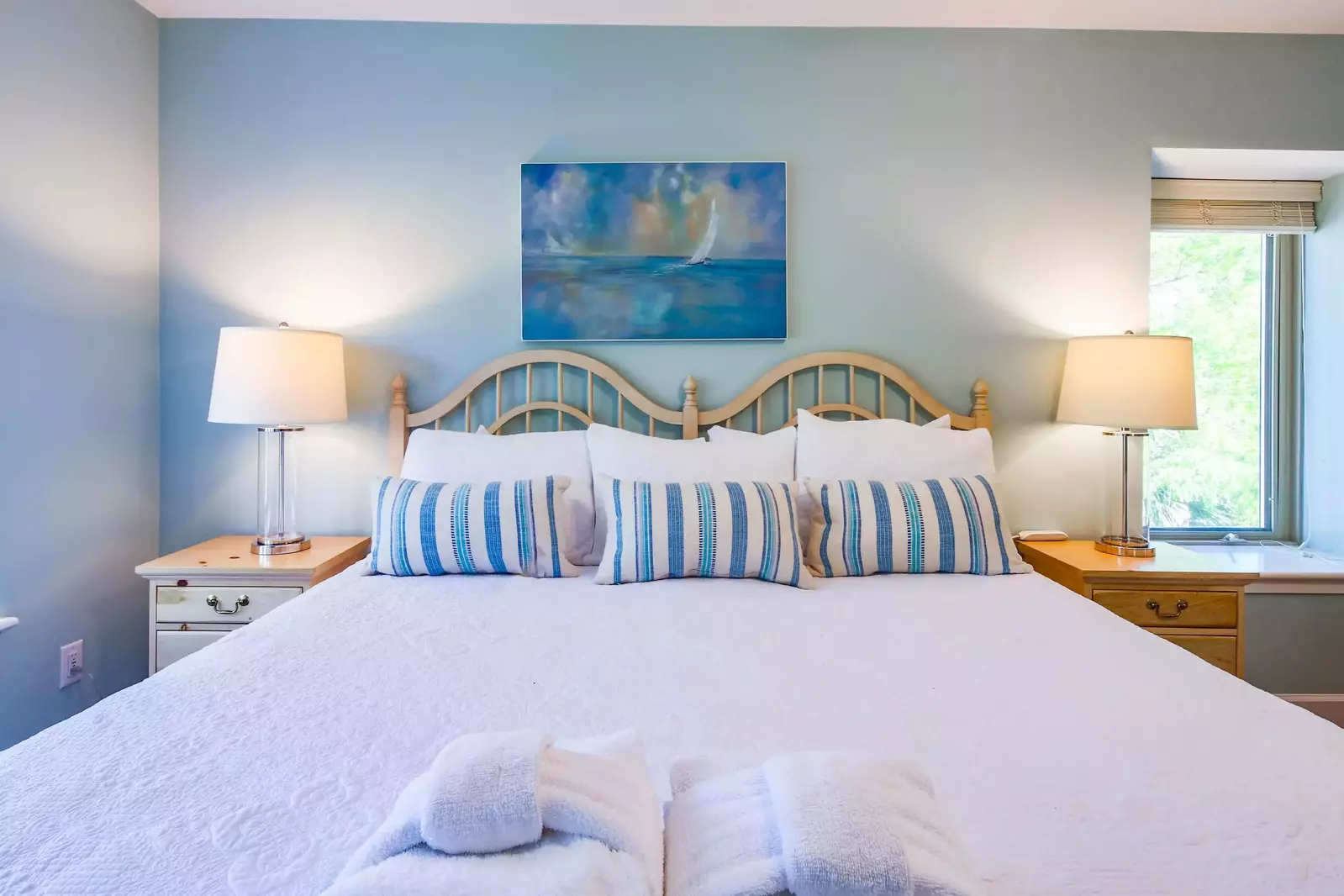 The master suite features a king bed and night stands with reading lamps.