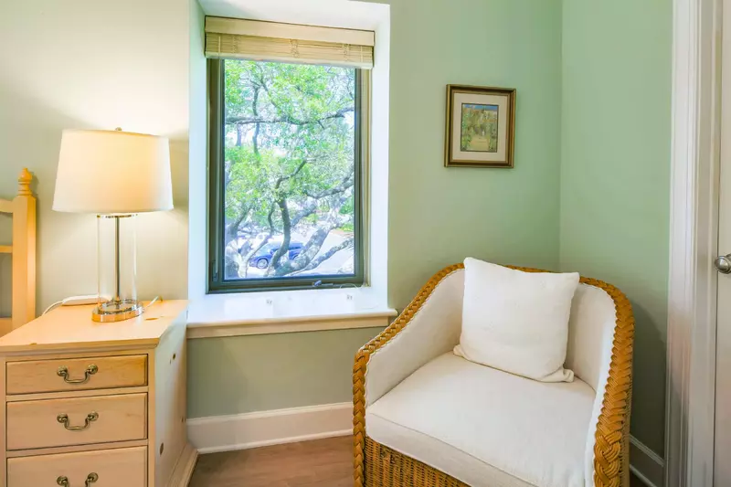 The master suite also has an arm chair near the closet and en suite bathroom.