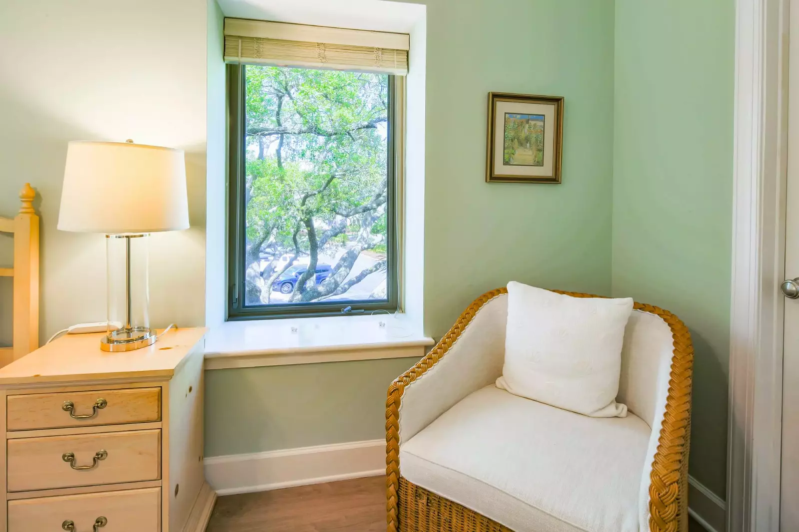 The master suite also has an arm chair near the closet and en suite bathroom.