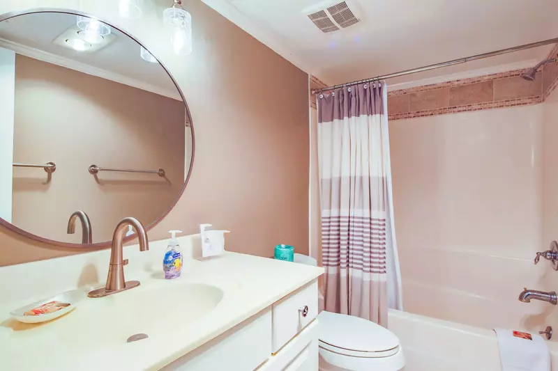 The hallway bathroom features a spacious vanity and a shower/tub combo.