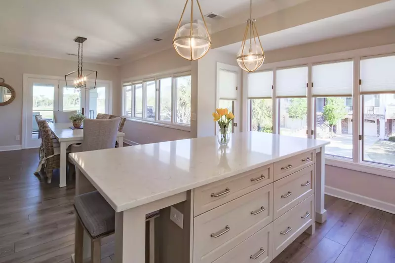 The dining area flows into this central island within the gorgeous kitchen.