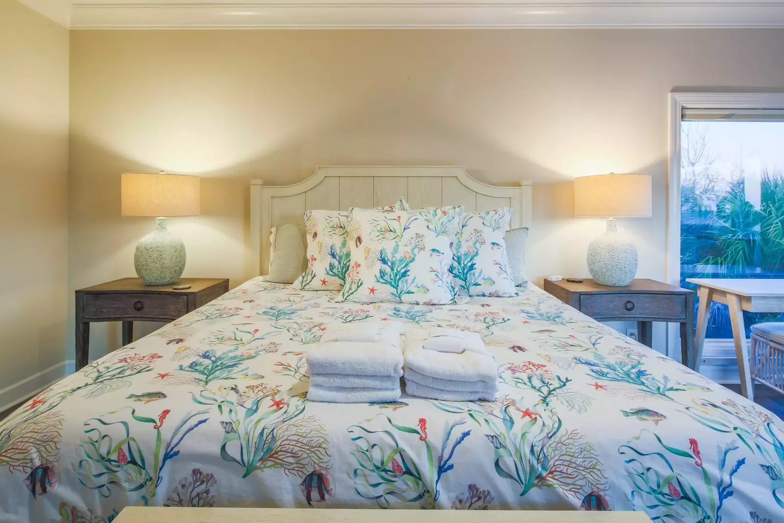 The master suite features a king bed and night stands with reading lamps.