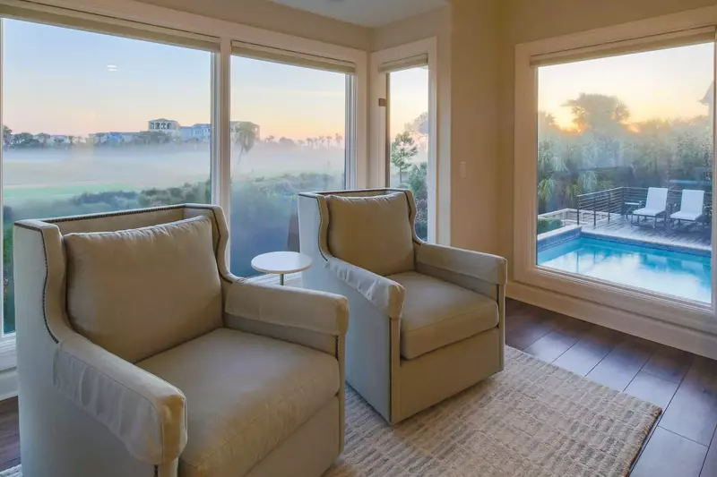 There are also two armchairs and views of the pool, sundeck and Robert Trent Jones golf course.