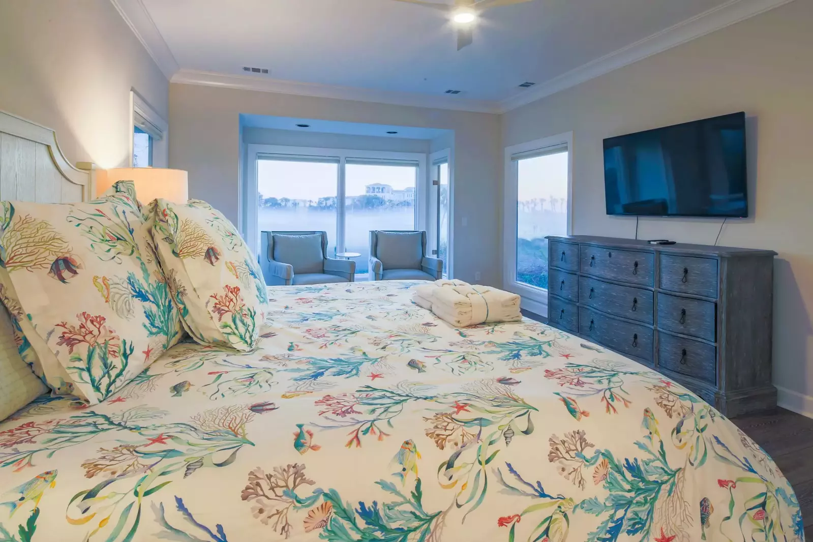 The master suite also has a dresser and wall-mounted TV.