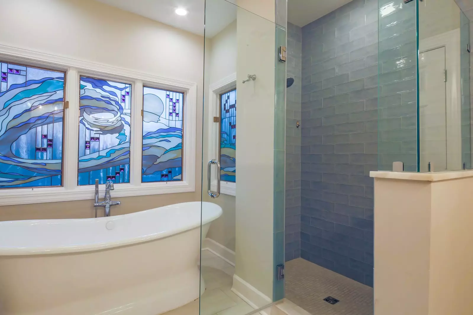 There is also a tiled, walk-in shower and beautiful stained glass windows within the master bathroom.
