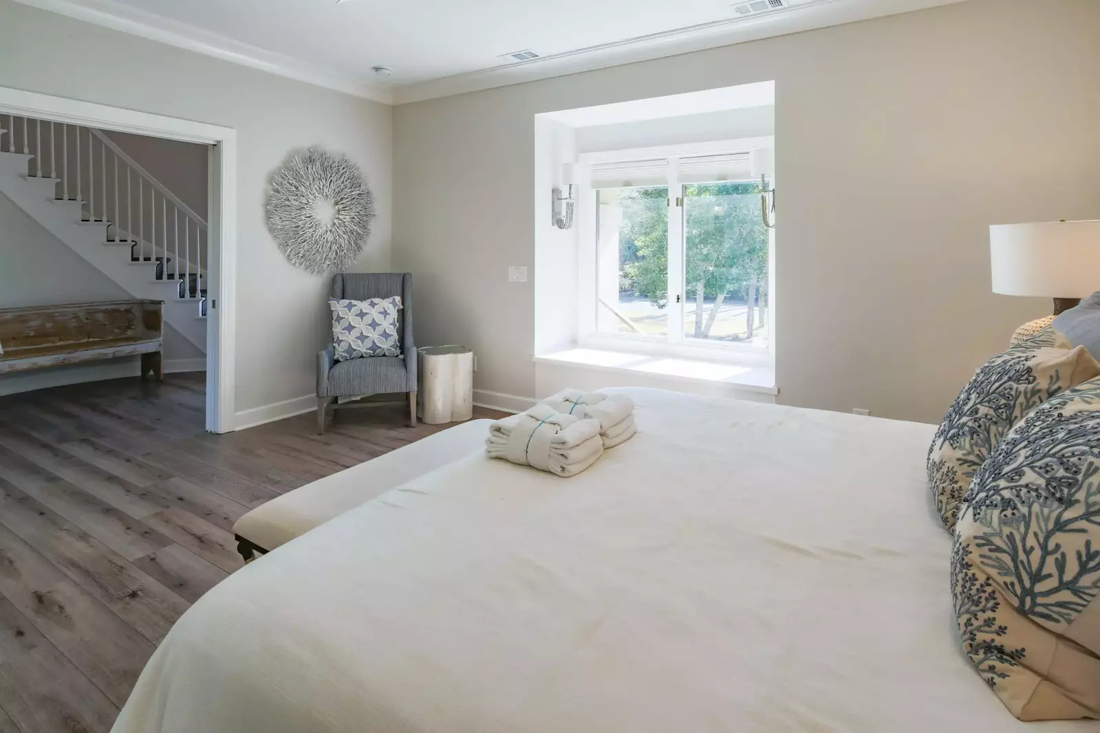 There is also an armchair and gorgeous flooring in this second master suite.