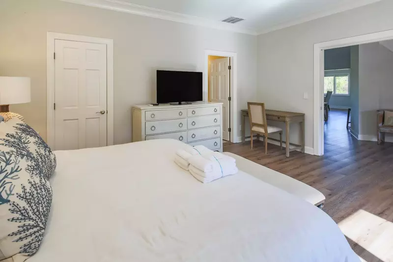 The second master suite also features a dresser, TV, desk and en suite bathroom.