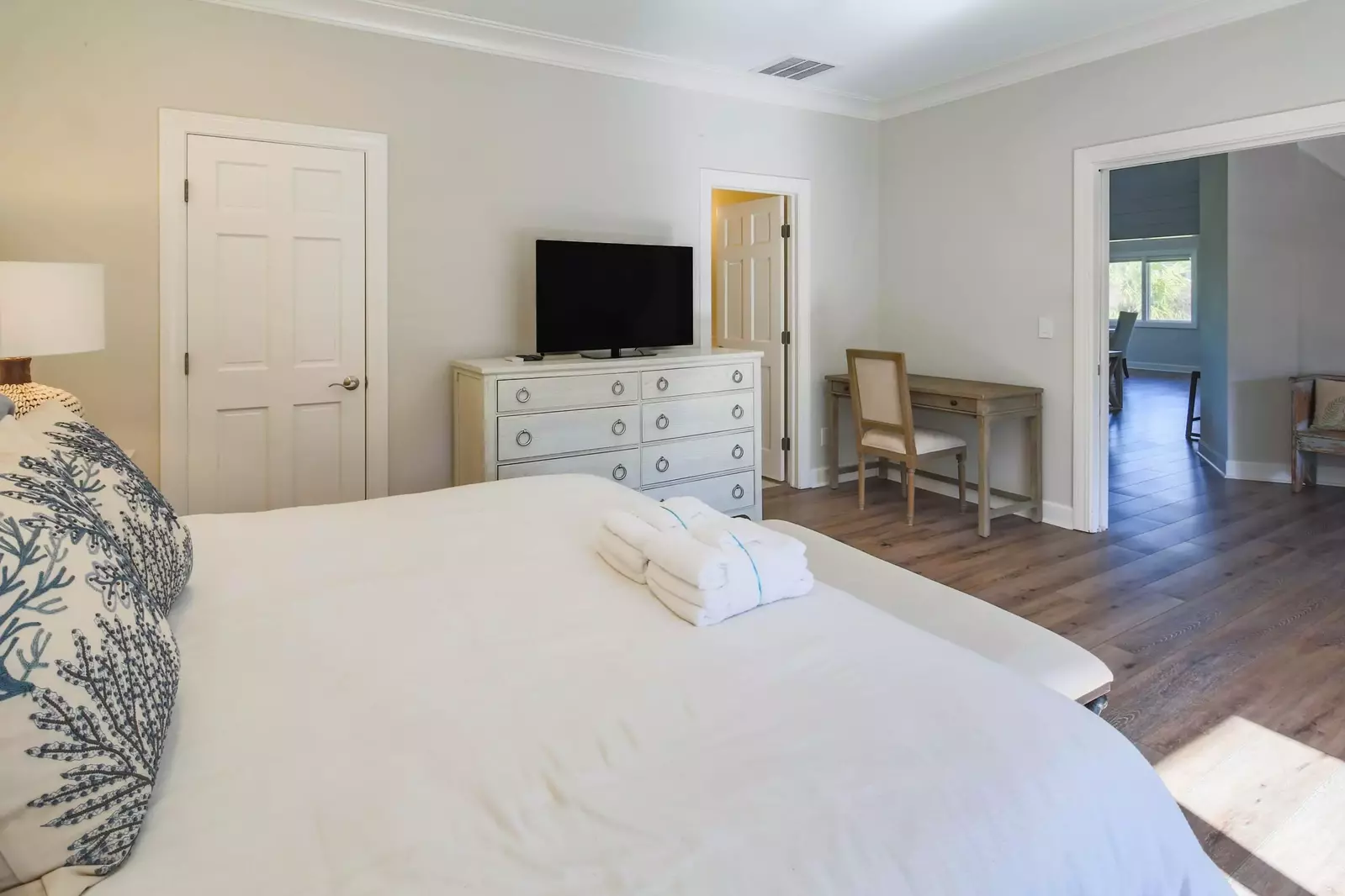 The second master suite also features a dresser, TV, desk and en suite bathroom.
