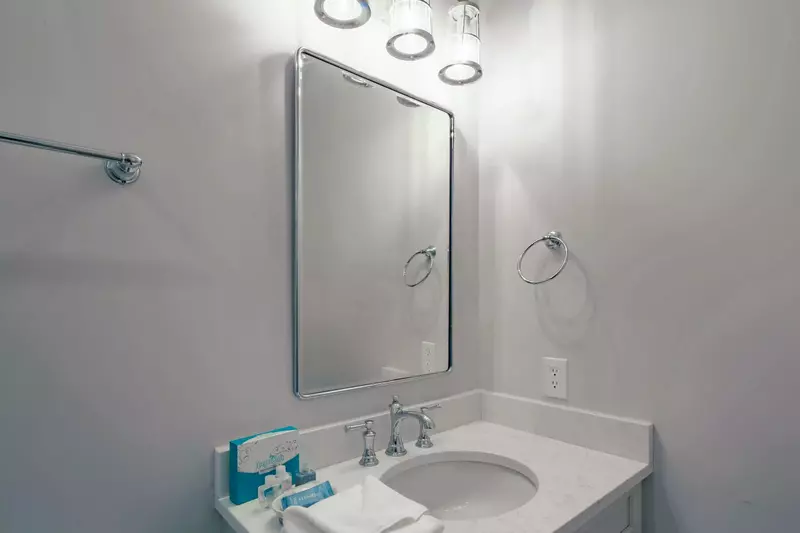 The en suite bathroom for the second master suite has a spacious vanity.