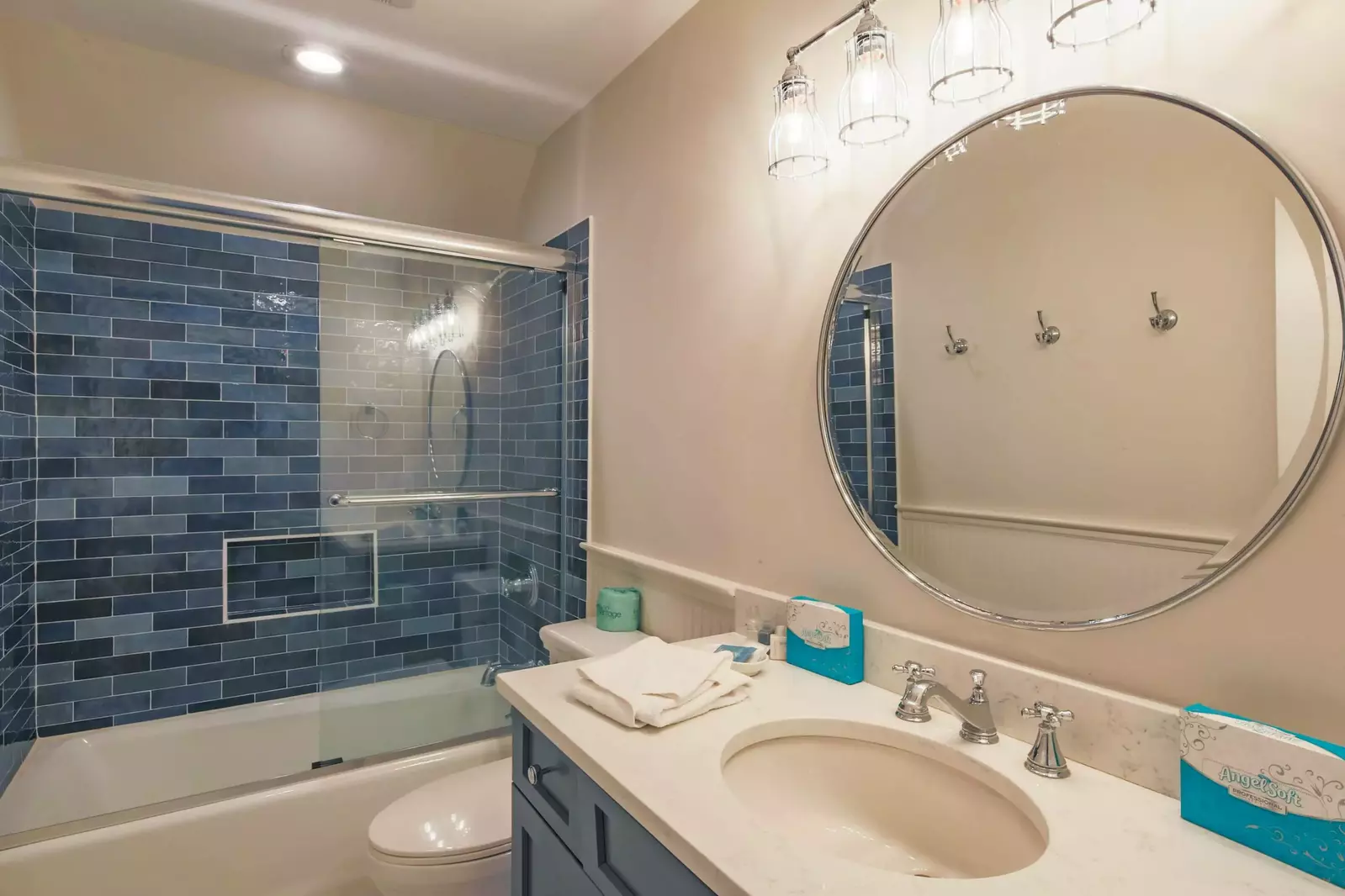 The en suite bathroom for the bunk bedroom features a shower/tub combo and spacious vanity.