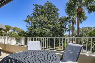 The partially covered balcony off the kitchen features glorious views of the magnolia near the villa.