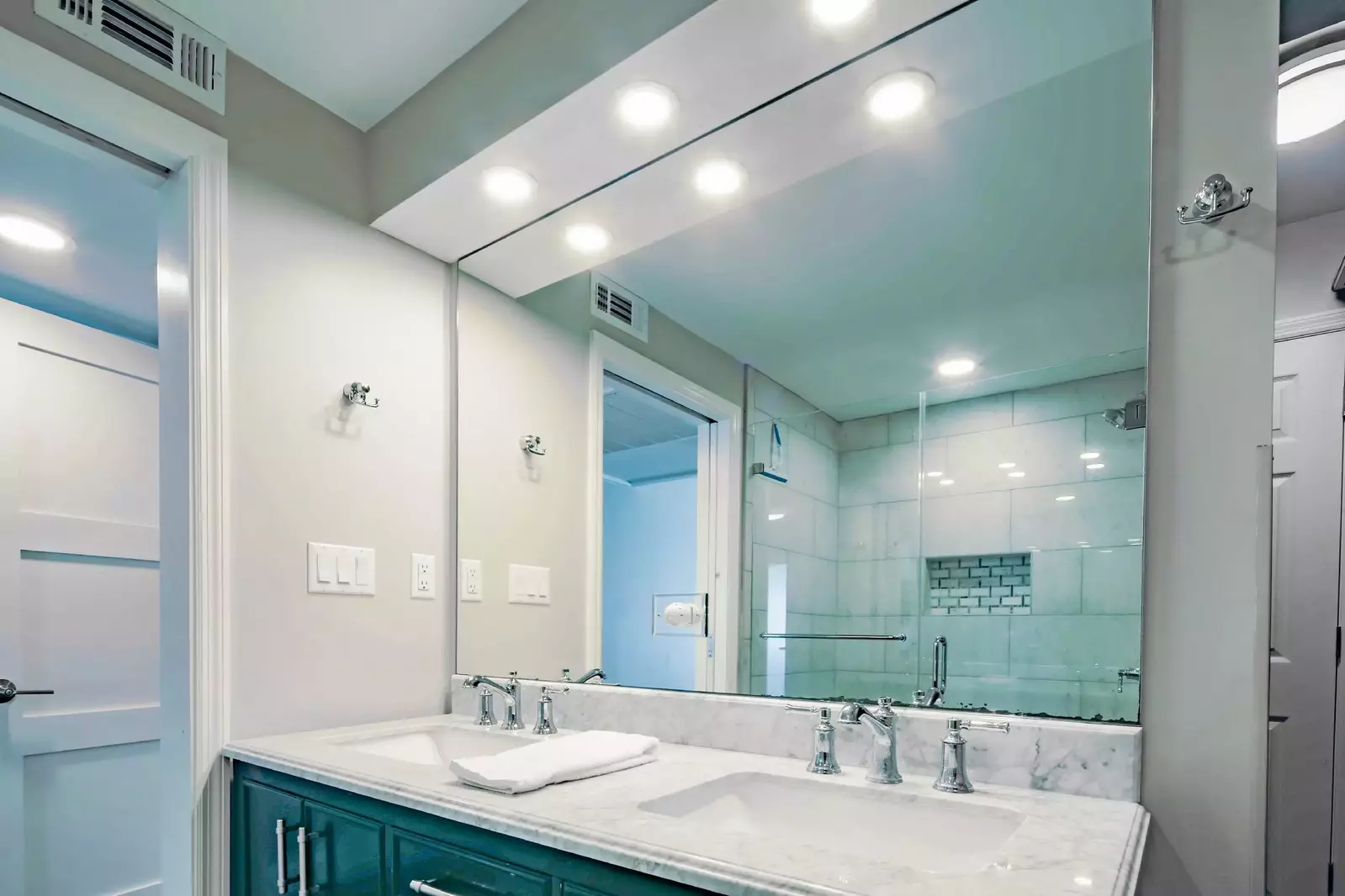 The en suite bathroom has a dual-sink vanity.
