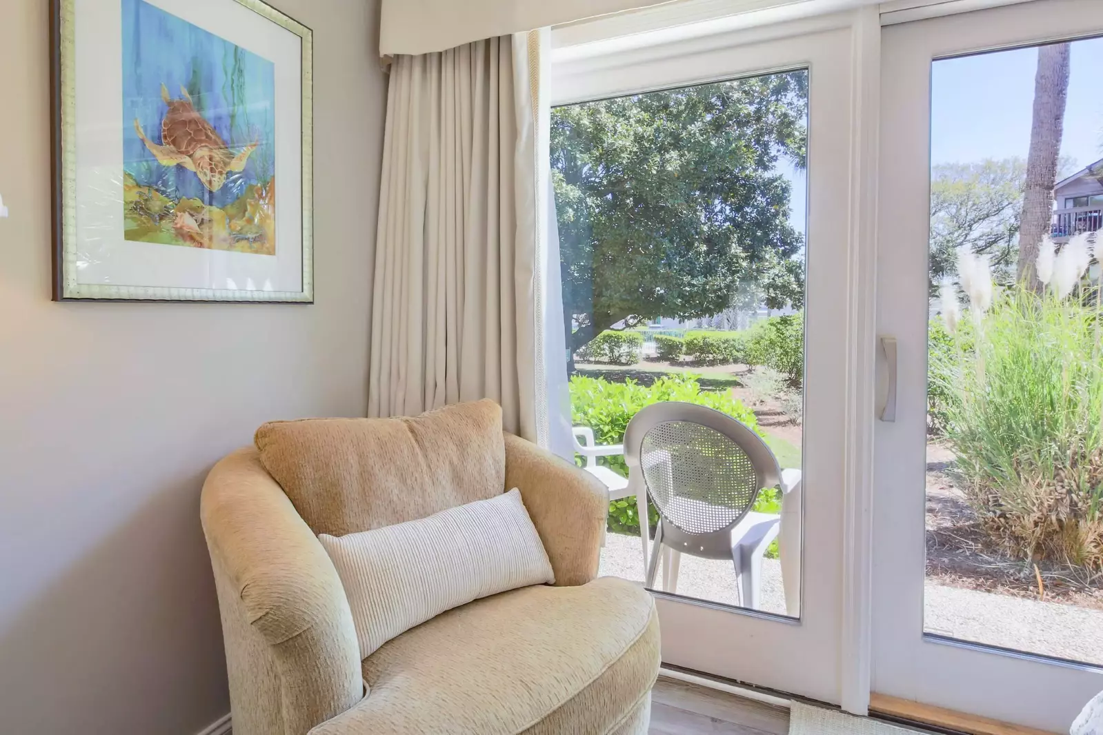 The queen suite also has an arm chair and views of the magnolia tree.