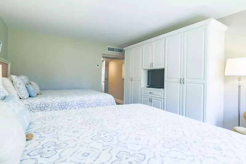 The queen suite has a built-in dresser, TV and en suite bathroom.