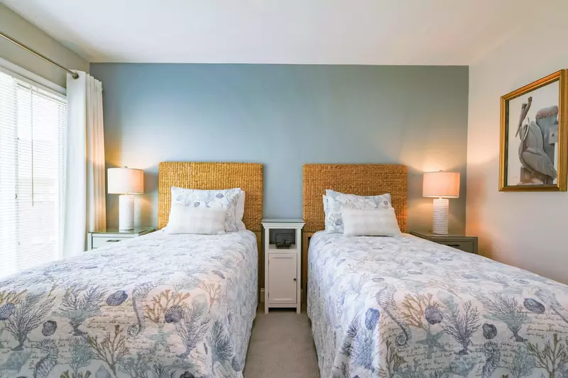 The twin suite features three night stands and two reading lamps.