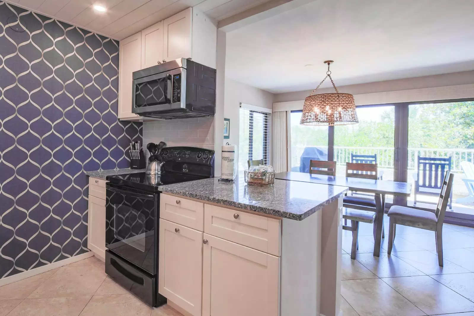 The kitchen also features an electric range, microwave and refrigerator.