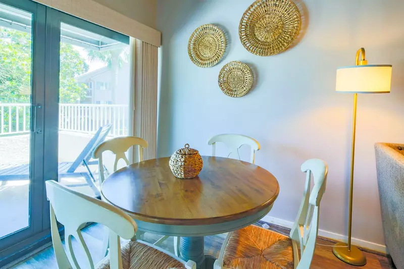 This table, which seats 4, is located in between the living room sectional and the back porch.