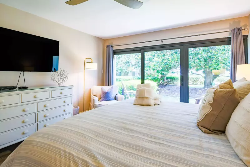 The master suite also sliding door access to the back patio and views of the large magnolia in the backyard.
