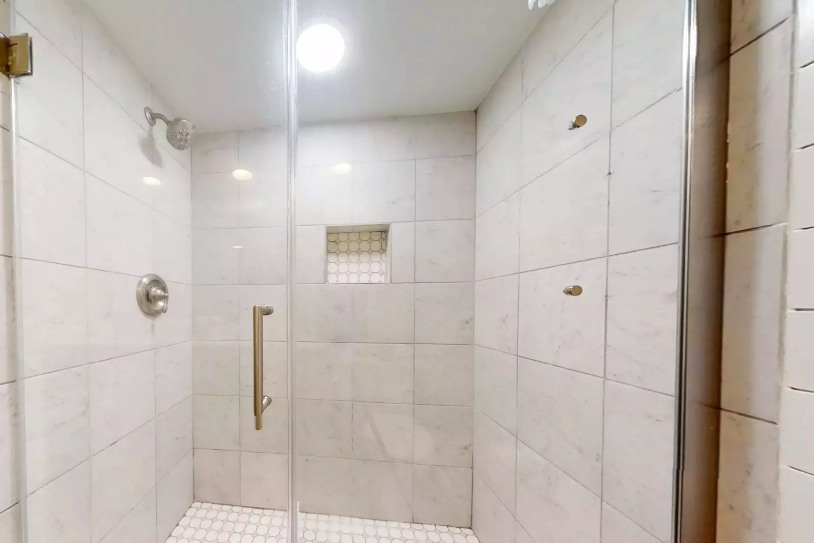The en suite bathroom for the master suite also features a tiled, walk-in shower.
