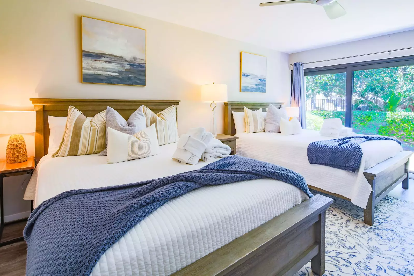 The guest suite features two queen beds and night stands with a reading lamps.