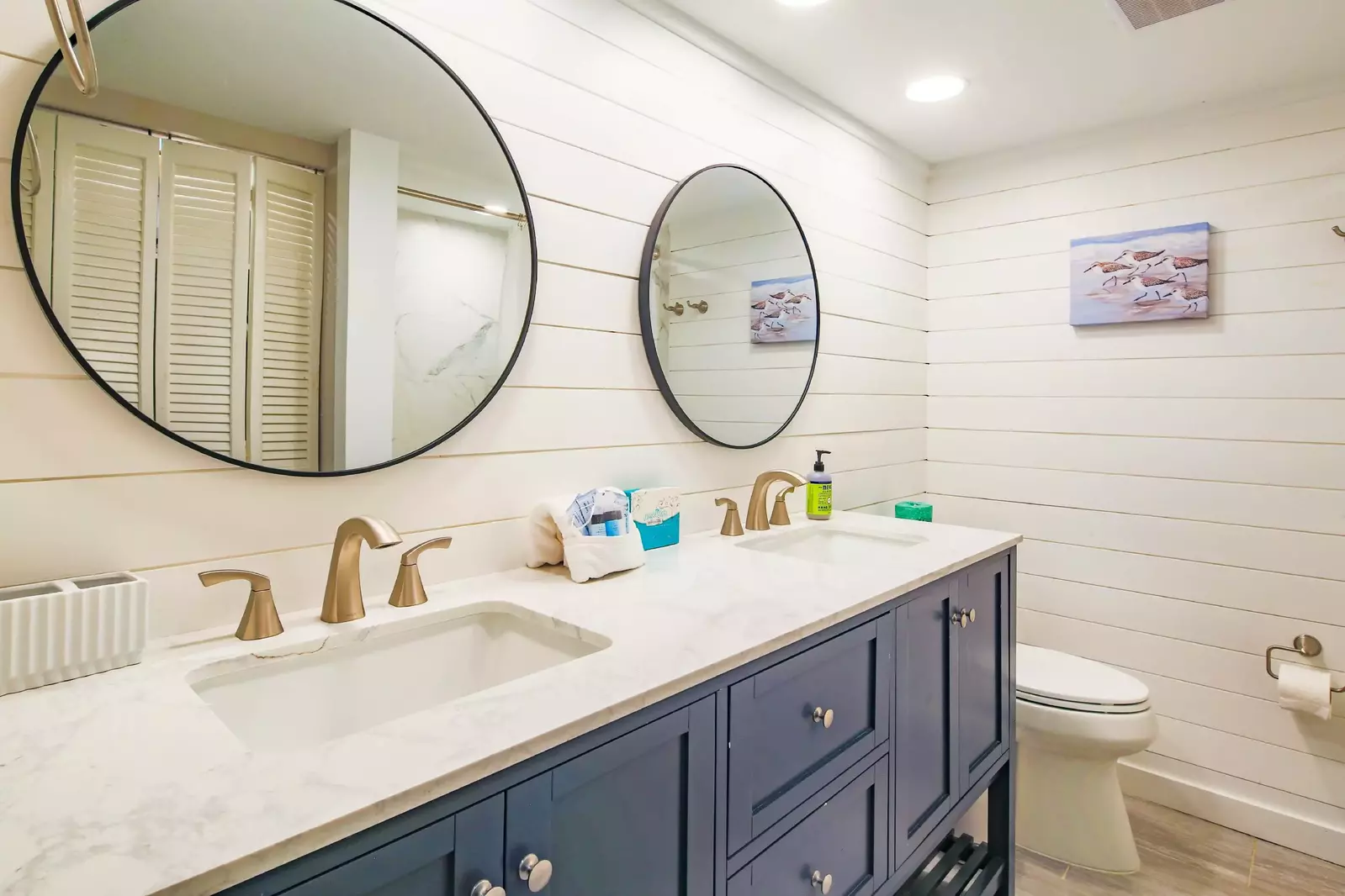 The en suite bathroom for the guest suite features a spacious vanity and a tiled shower.