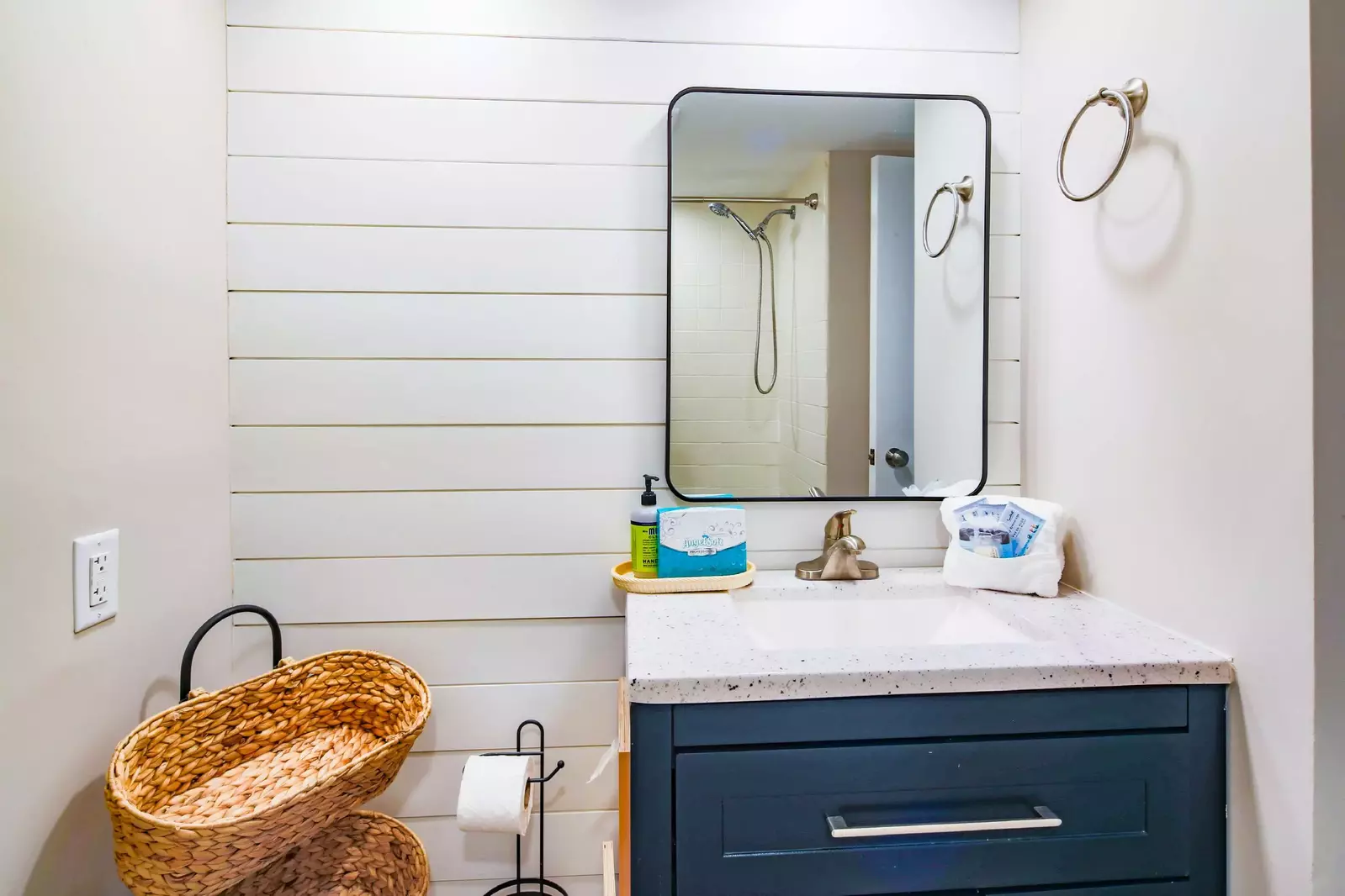 This renovated bathroom is located near the kitchen.