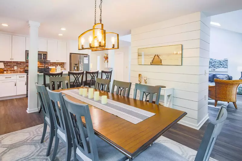 The dining table seats 8 and there are 4 stools at the kitchen counter.