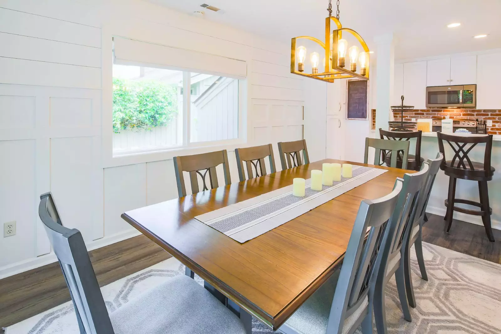 The walls in the dining room have both shiplap and wainscoting for a clean, coastal look.