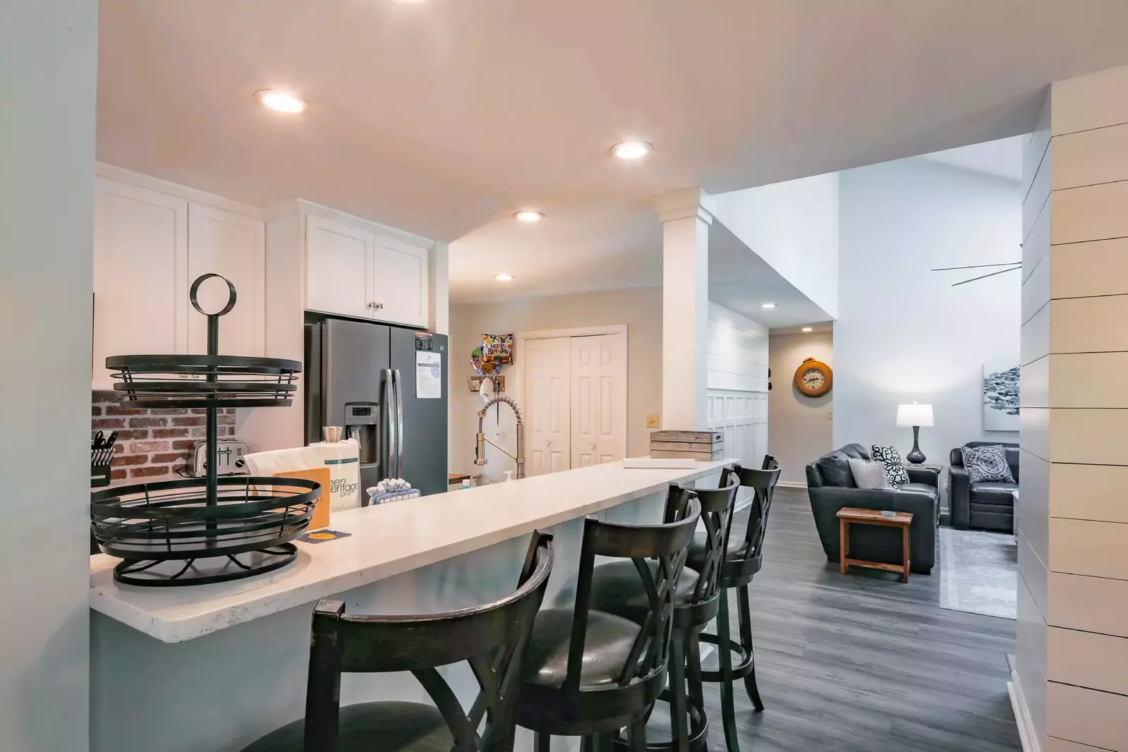 The kitchen features a high top counter with four high top stools.