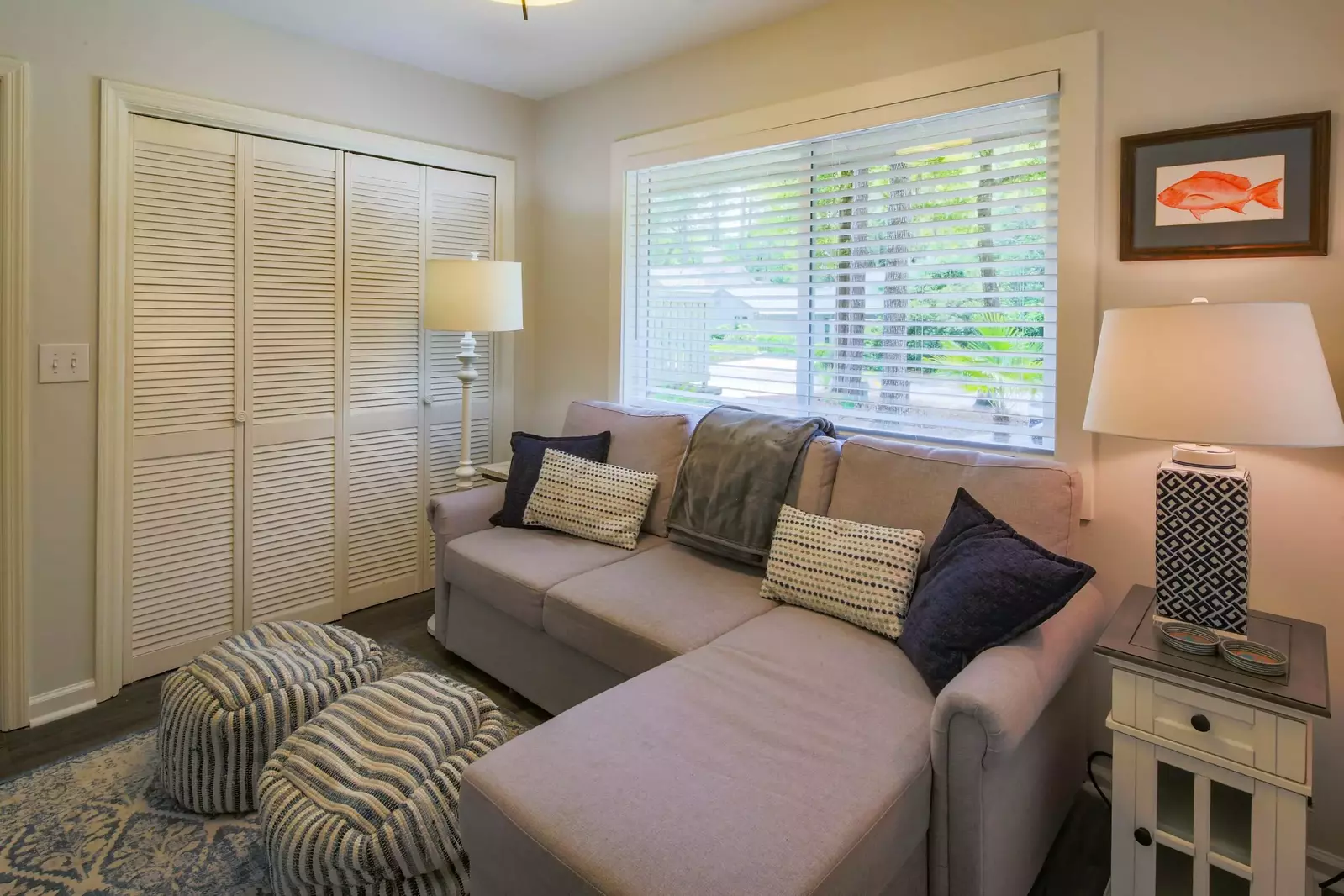 The den features a sofa with a chaise.